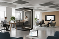 Modern hybrid office with three people working simultaneously in different zones — desk, phone pod, and lounge — with a tablet showing a Hybrid Readiness Score of 72/100